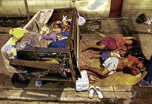 Children sleeping on sidewalk